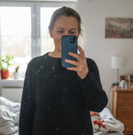 Woman around 60. Polish nationality. Selfie in the mirror in black tights. Realistic feeling like from an iphone camera.